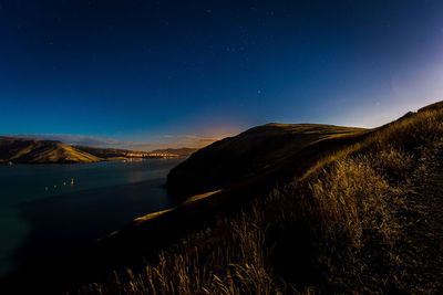 Scenic view of landscape against clear sky at night