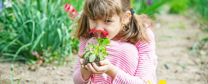 Portrait of girl smelling flower