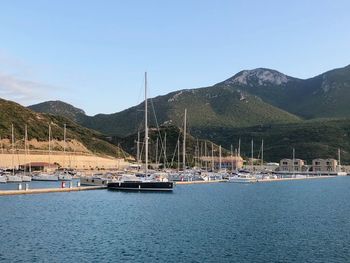 Sailboats in sea against sky