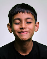 Portrait of young man against white background