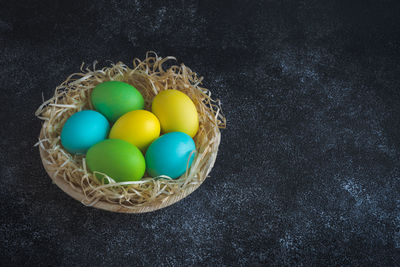 High angle view of multi colored eggs in basket
