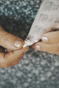 Cropped hand of person holding paper currency