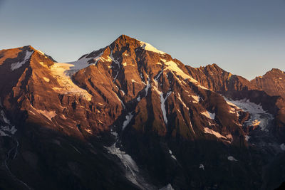 Scenic view of snowcapped mountains against clear sky