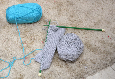 High angle view of knitting needles and wool