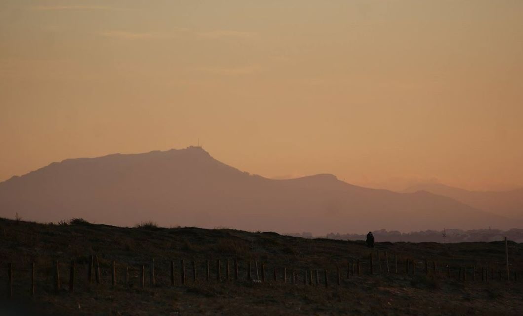 SCENIC VIEW OF SILHOUETTE MOUNTAINS DURING SUNSET