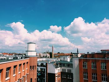 Low angle view of buildings against cloudy sky