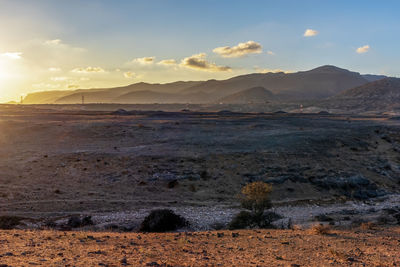 Scenic view of desert against sky during sunset