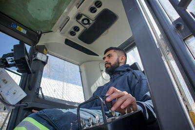 Low angle view of man working in drill