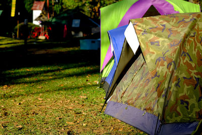 Close-up of multi colored umbrella on field