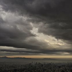 Scenic view of landscape against cloudy sky