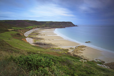 High angle view of calm beach against blue sky