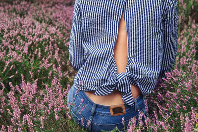 Low section of woman standing on field