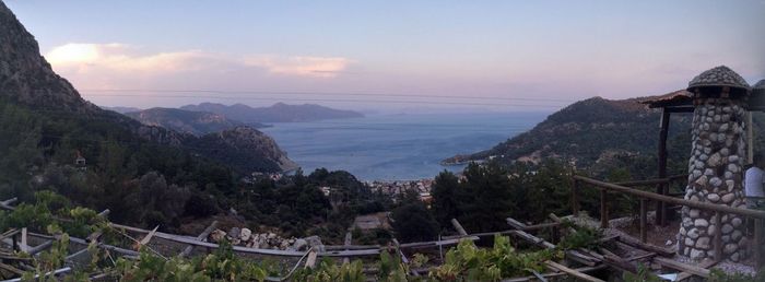 Scenic view of sea and mountains against sky