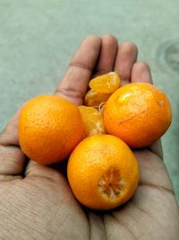 Close-up of hand holding orange