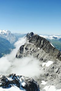 Scenic view of snow capped mountains against clear sky