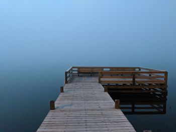 Pier over sea against clear sky