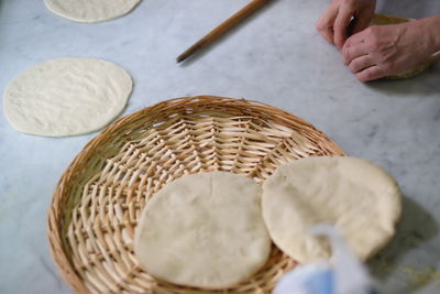 Cropped hands preparing food at table in kitchen