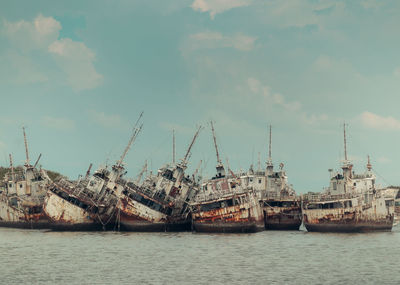 Several phinisi shipwrecks just piled up in the waters of the port of paotere, makassar, indonesia.