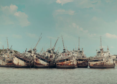 Several phinisi shipwrecks just piled up in the waters of the port of paotere, makassar, indonesia.