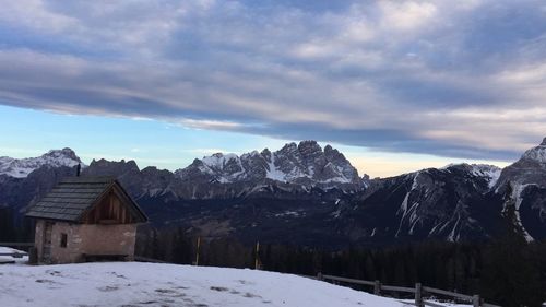 Houses on snowcapped mountains against sky