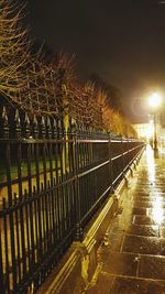 Illuminated railing against sky at night