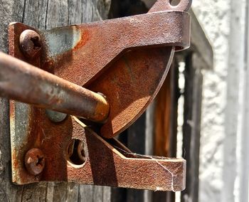 Close-up of rusty metal on wood