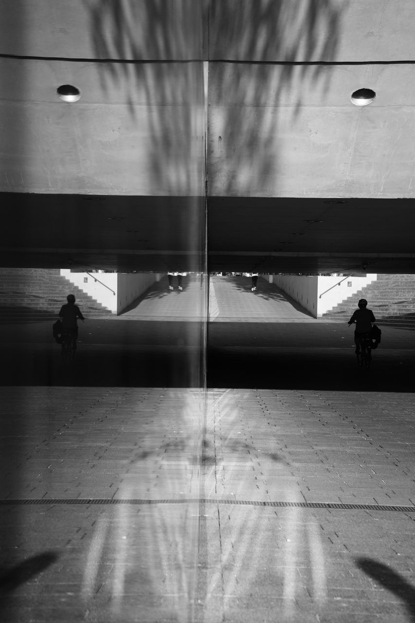 SILHOUETTE PEOPLE WALKING ON FOOTPATH IN CITY
