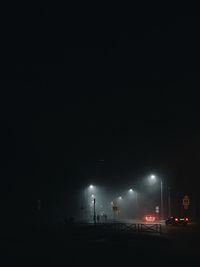 Illuminated street lights in city at night