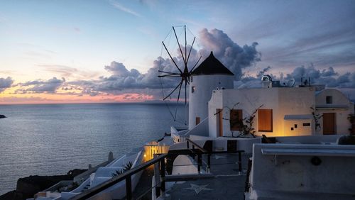 Lifeguard hut by sea against sky during sunset