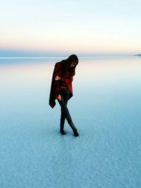 Full length of woman at beach against sky