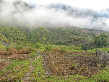 Scenic view of mountains against cloudy sky