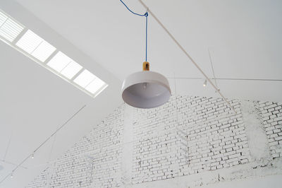 Low angle view of cables hanging against clear sky