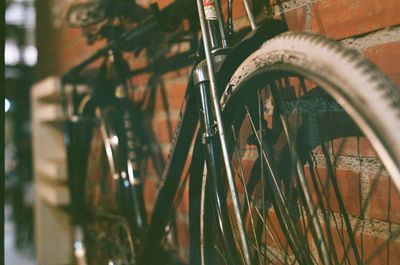 Close-up of bicycle wheel by building