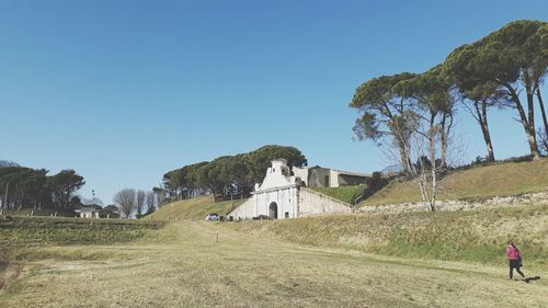 Scenic view of field against clear blue sky