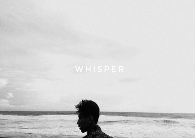 Man with text on beach against sky