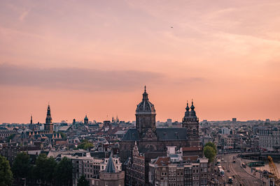 Buildings in city against sky during sunset amsterdam 