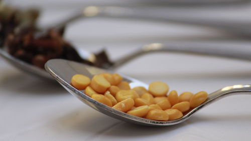 Close-up of bengal grams in spoon on table