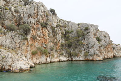 Scenic view of sea and mountains against clear sky