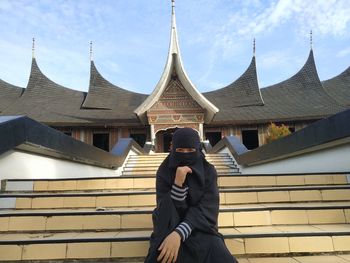 Full length of man standing against building