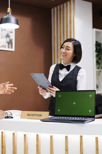 Portrait of woman using laptop at home