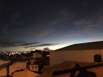 Buildings against sky at sunset