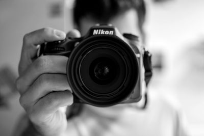 Cropped image of woman photographing through camera