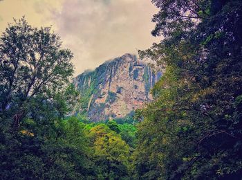 Scenic view of mountains against cloudy sky