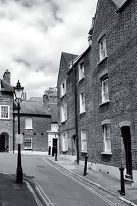 Street amidst buildings against sky