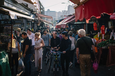 People walking on street market in city