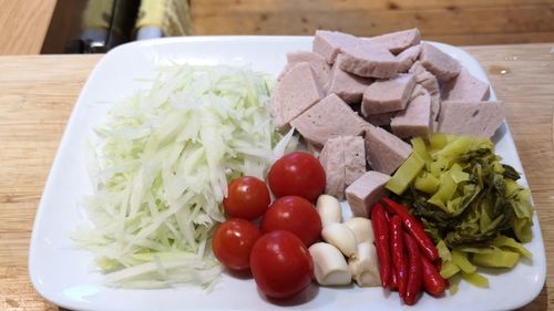 High angle view of chopped fruits in plate on table