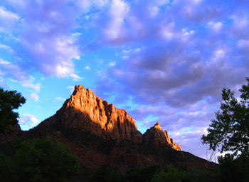 Scenic view of mountains against cloudy sky