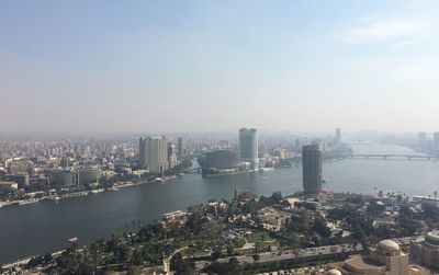 High angle view of river and buildings against sky