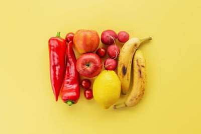 Healthy and organic food flay lay concept on yellow background. square made of different vegetables
