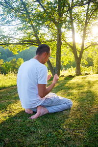 Young man sitting on field